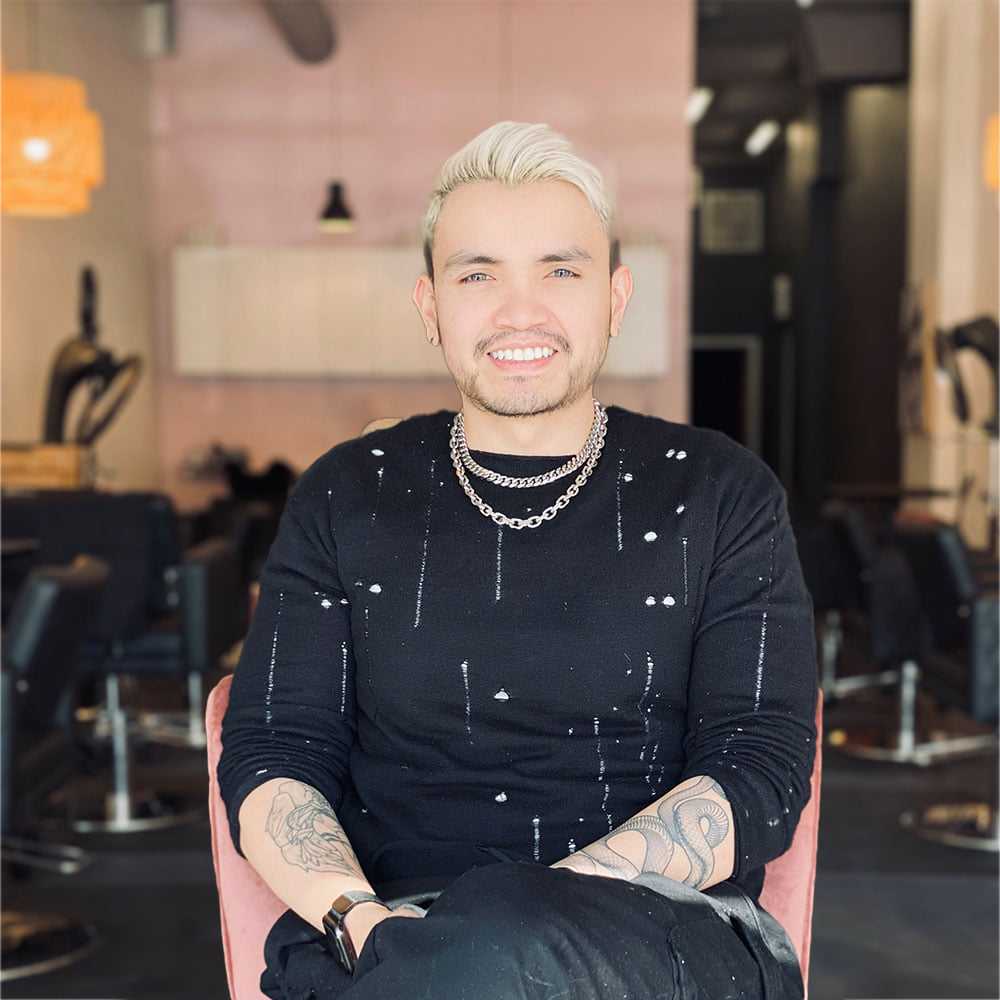 Portrait of Mykol Phan, a professional stylist at Isaac Crawford Salon, showcasing their expertise and style.