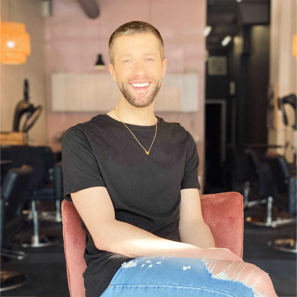 Portrait of Isaac Crawford, a professional stylist at Isaac Crawford Salon, showcasing their expertise and style.